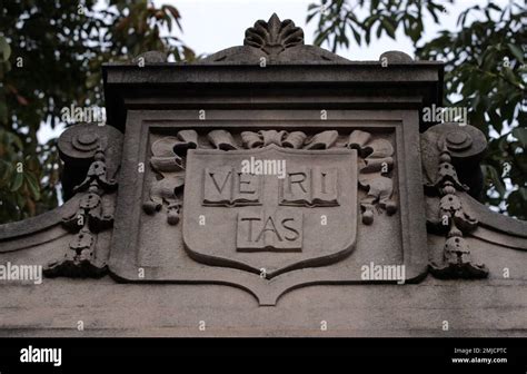 The motto "Veritas" on a gate of Harvard Yard at Harvard University in ...