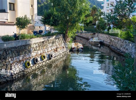 Small water canal in Turkish city. City landscape with canal, boats and ...