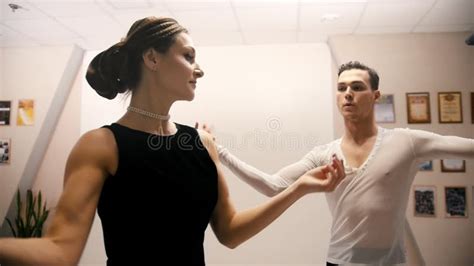 Young Beautiful Man And Woman Dancing Latin American Dance In Costumes