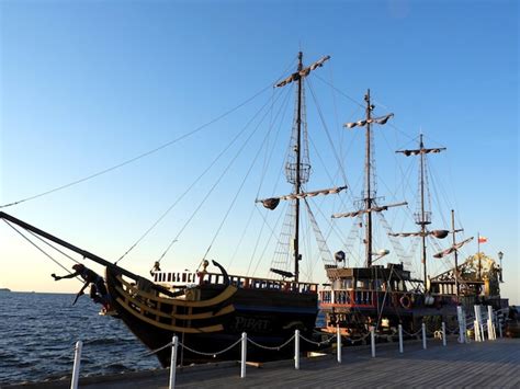 Premium Photo Sailboats Moored At Harbor Against Clear Sky