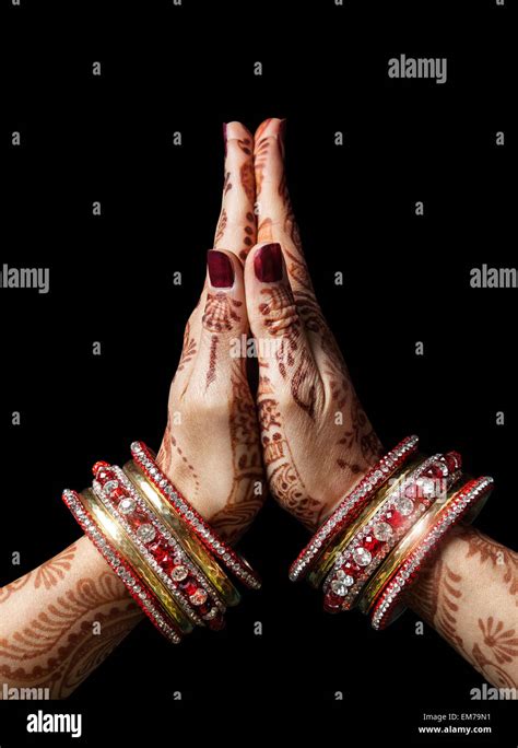 Woman Hands With Henna In Namaste Mudra On Black Background Stock Photo