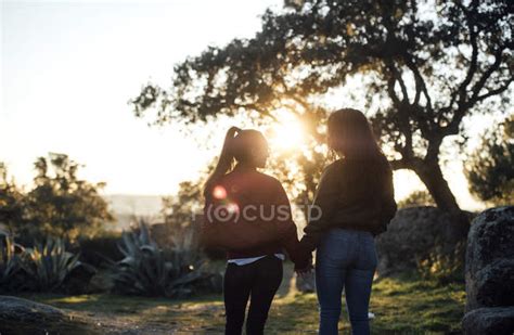 Lesbian Couple Holding Hands Backlight Alternative Stock Photo
