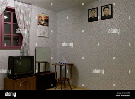 Mock-up of North Korean family home interior displaying portraits of Kim Il Sung and Kim Jong Il ...