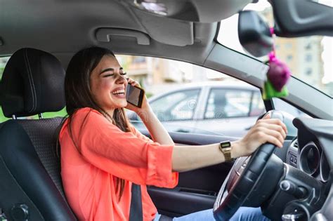 Businesswoman Driving Car And Talking On Cell Phone Concentrating On