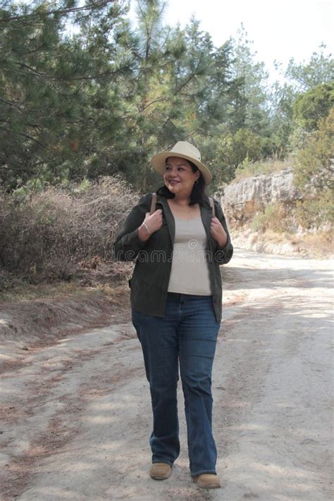 40 Year Old Latina Woman Points To Something That She Likes Surprises And Excites Such As