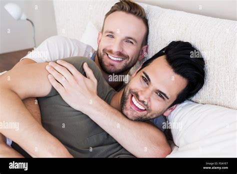 Happy Gay Couple Lying On Bed Stock Photo Alamy
