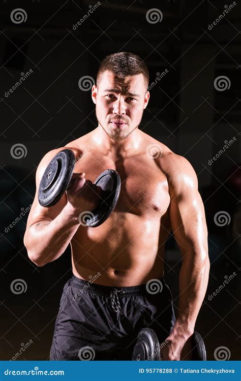 Muscular Man Working Out In Gym Doing Exercises With Dumbbells At Biceps Strong Male Naked