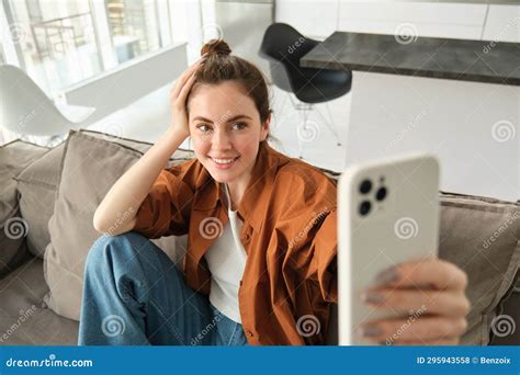 Portrait Of Stylish Modern Young Woman Taking Selfie On Smartphone