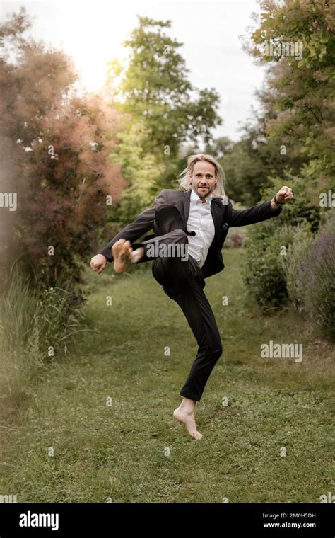 Businessman, 40, barefoot in suit, walks in nature Stock Photo - Alamy