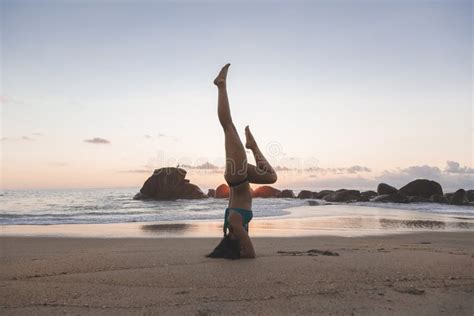 Young Attractive Latin Woman Wearing A Bikini Practicing Yoga On The