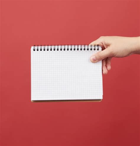 Premium Photo Hand Holding An Open Spiral Notebook With Empty White