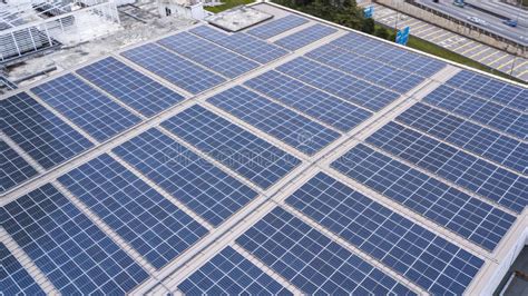 Aerial View Of A Solar Panel Photovoltaic With Reflection On Building