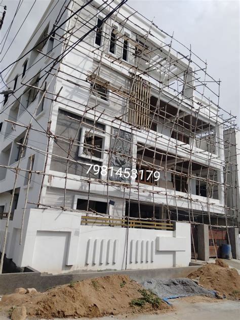 A Large White Building With Scaffolding Around It