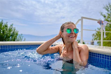 Woman Coming Out Of Pool Seductive Model In Swimsuit With Blonde Hair Posing At Pool Looking