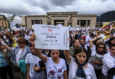 Thousands of Colombians march against violence after car bomb kills 20 ...