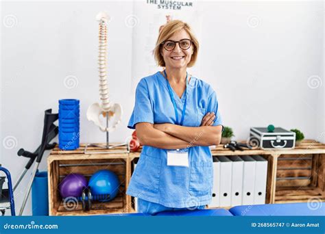 Middle Age Blonde Woman Wearing Physio Therapy Uniform Standing With