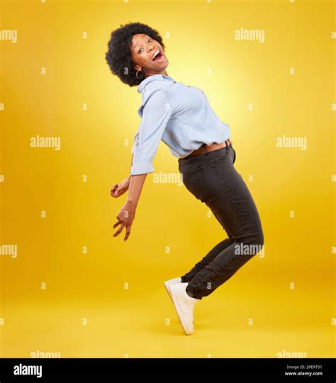 Wow, excited and happy black woman in dance pose on yellow background ...