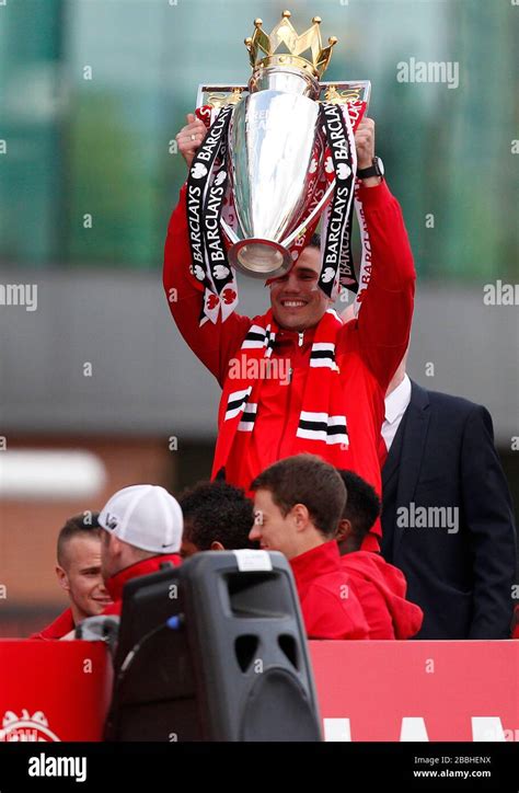 Manchester United's Robin van Persie celebrates by lifting the trophy ...