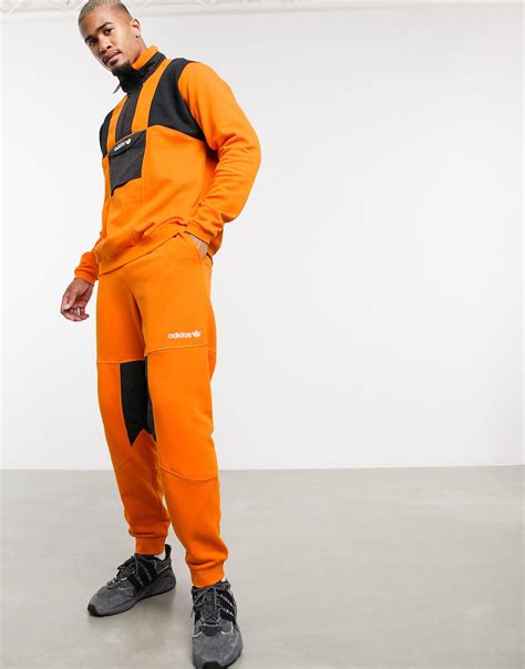 Geliehen Türöffnung Isolierung adidas jogginghose schwarz orange