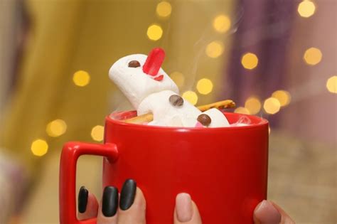 Premium Photo Marshmallow Snowman In Hot Chocolate In A Red Cup