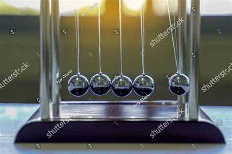 The Newton S Cradle Is A Device That Demonstrates The Conservation Of