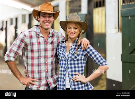 portrait of cowboy cowgirl couple inside stable Stock Photo - Alamy