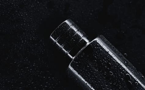 Premium Photo | Black perfume on a dark background close up