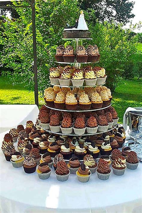 A Table Topped With Lots Of Cupcakes And Muffins On Top Of Each Other