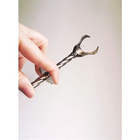 A Person Holding A Pair Of Scissors In Their Right Hand And The Other