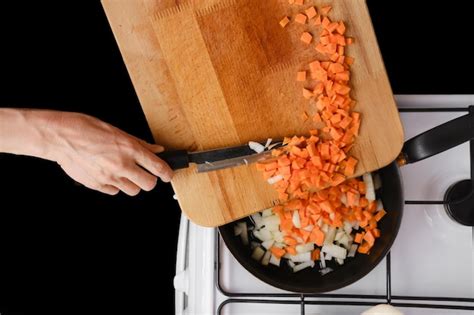 Premium Photo Put Chopped Onion And Carrot On A Frying Pan