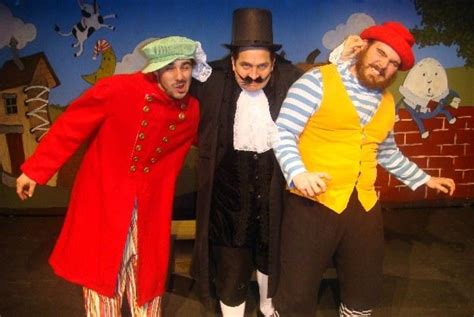 Three Men Dressed In Costumes Standing Next To Each Other And Posing