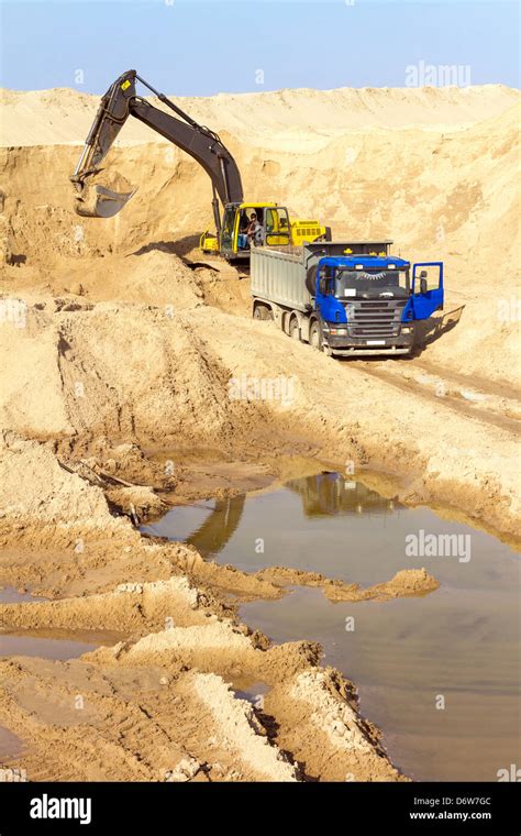 Excavator Loading Dumper Truck At Construction Site Stock Photo Alamy