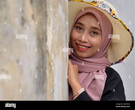 Beautiful Young Malaysian Malay Woman Wears A Modern Sun Hat With Her