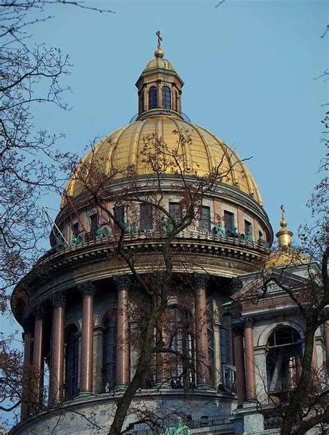 An Old Building With A Golden Dome On Top And Trees In The Foreground