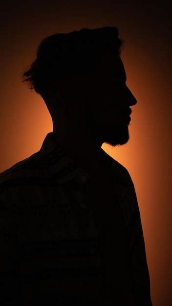 Premium Photo Close Up Of Silhouette Man Against Orange Background