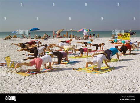 Yoga classes are held on the white sand beach of Siesta Key, a resort ...