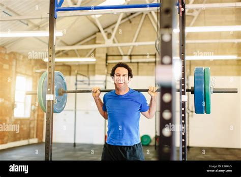 Man Lifting Barbell In Gym Stock Photo Alamy