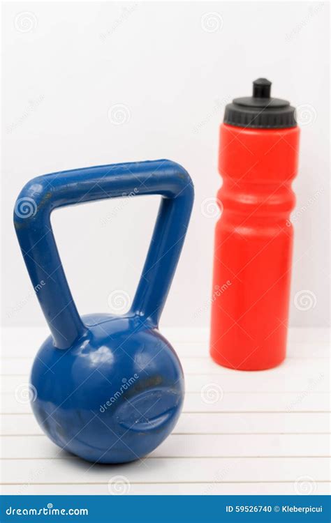 Kettlebell And Water Bottle On A White Wooden Floor Stock Photo Image