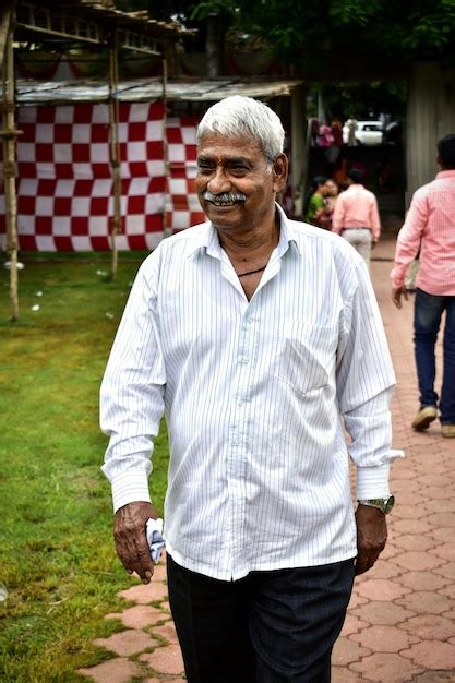 Premium Photo Senior Man Looking Away While Walking On Footpath