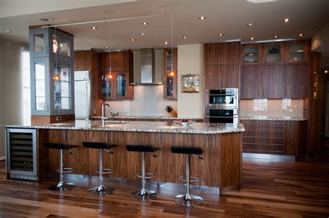 A Large Kitchen With Wooden Floors And Stainless Steel Appliances