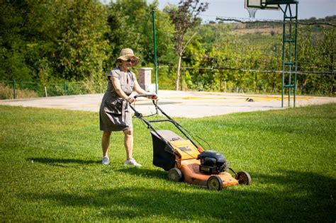 Senior Woman Mowing Grass Stock Photo Download Image Now Istock