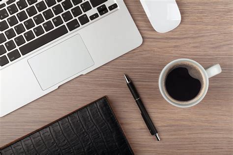 Notepad Laptop And Coffee Cup On Wood Table View From Above Center