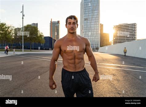 Crop Masculine Athlete With Naked Torso And Muscles Looking At Camera