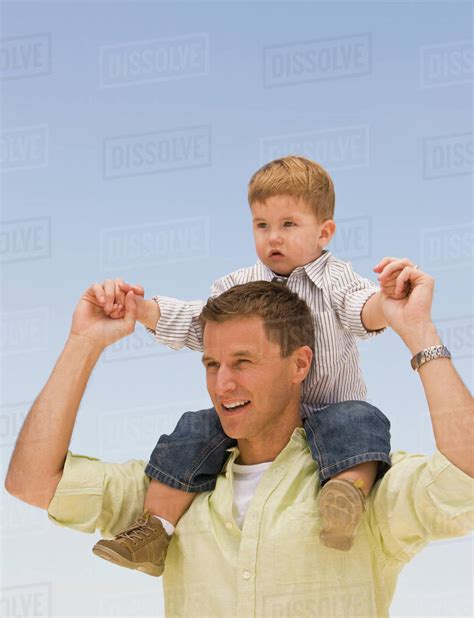 Father Holding Son On Shoulders Stock Photo Dissolve