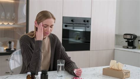 During A Headache A Woman Throws An Aspirin Tablet Into A Glass Of