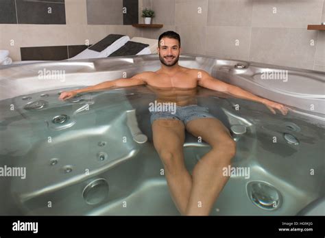 Wellness Spa Man Relaxing In Hot Tub Whirlpool Jacuzzi Indoors At Luxury Resort Spa Retreat