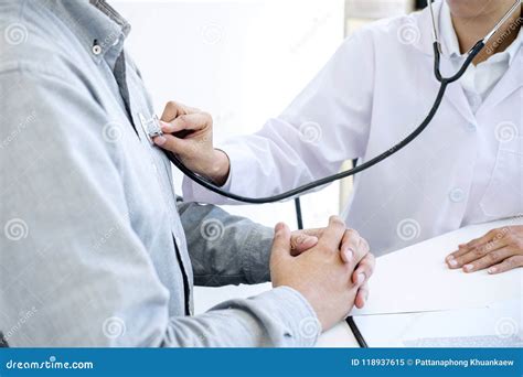 Female Doctor Checking Heart Beat Of Patient And Recommend Treat Stock