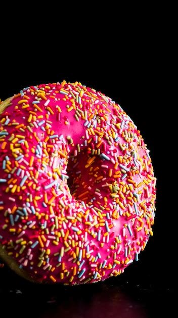 Premium Photo Pink Glazed Donut With Sprinkles Isolated Close Up Of