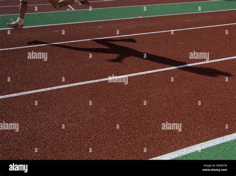 Shadow of a runner on a running track Stock Photo - Alamy