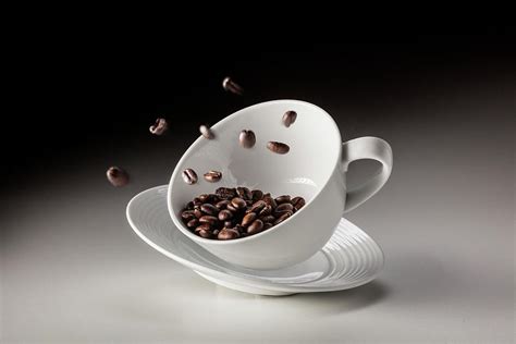 Falling Coffee Cup With Coffee Beans By Bjorn Holland